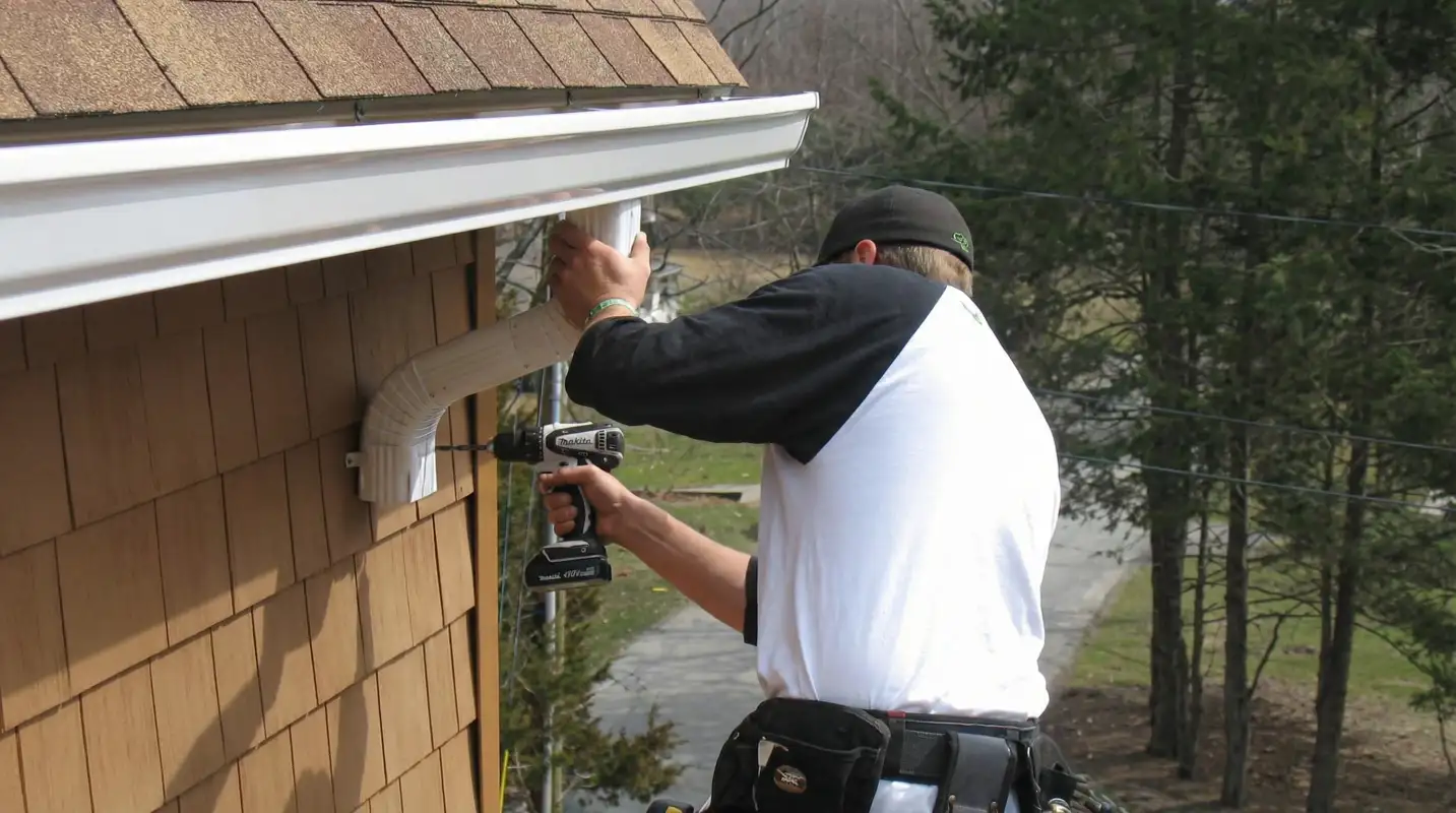 Professional contractor installing tan vinyl siding panels on a residential home exterior in Clearwater, FL