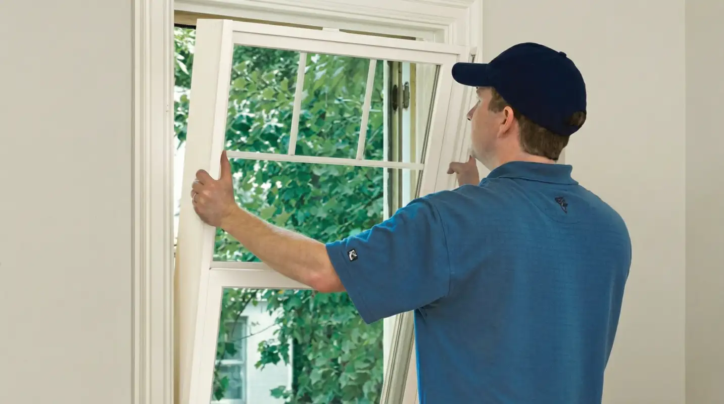 Professional contractors performing a residential window insulation and replacement service in Clearwater, FL